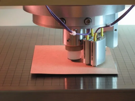 Archival close view of the SoniSys OPUS 3-D sensor head positioned over a sheet specimen